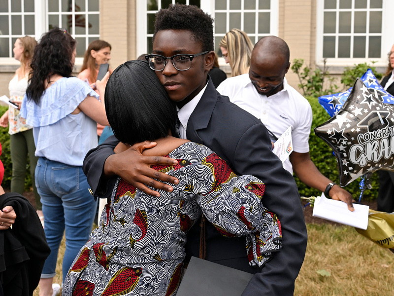 A student receives a hug after the 2023 Milton Hershey School Eighth Grade Promotion Ceremony.