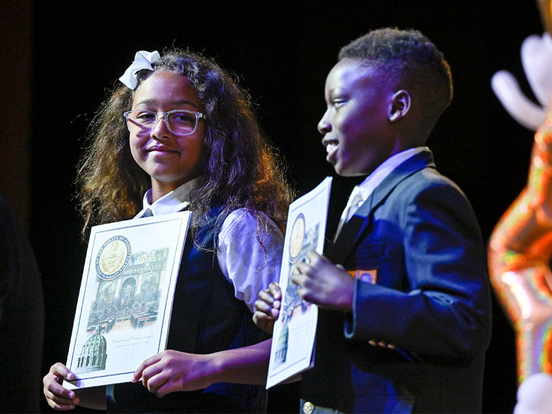 Milton Hershey School students hold award certificates during the Fourth-Grade Promotion Ceremony.