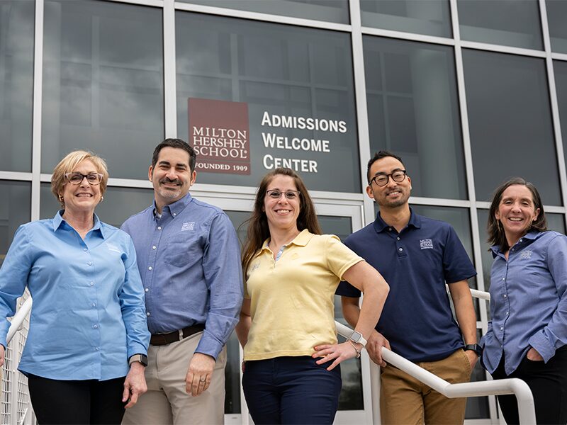 Admissions Counselors on steps at Welcome Center
