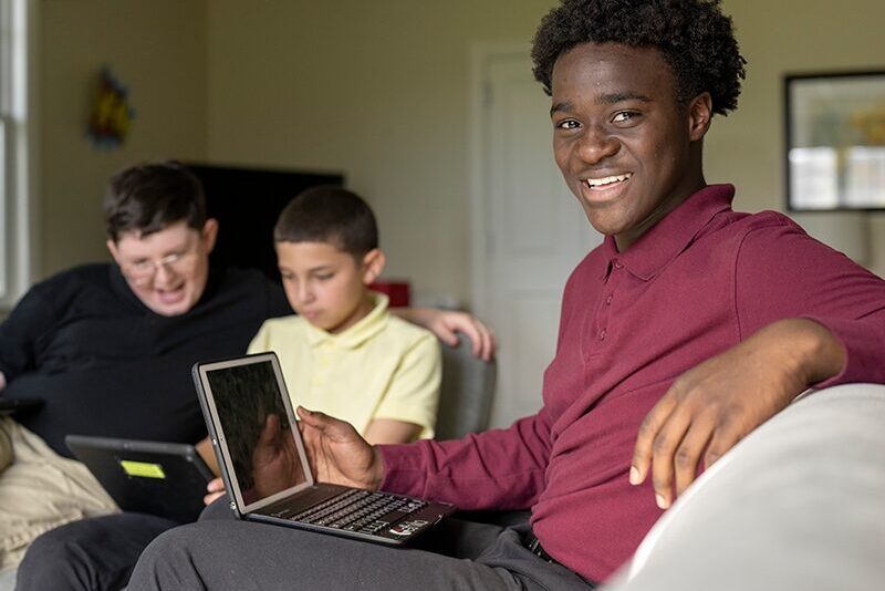Middle school students using technology in the student home