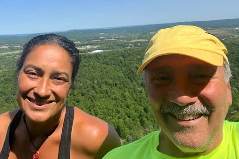 Aurita Maldonado ’01 hikes with her former houseparent, Randy Mladenoff.