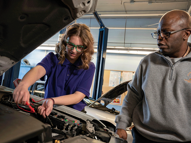 Jocelyn Crist, Milton Hershey School student stands with MHS teacher Victor Gibson while getting hands-on experience.