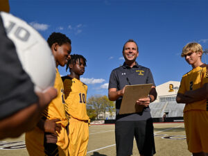 Milton Hershey School Boys' Soccer Coach Chris Spinagotti talking to players at practice.