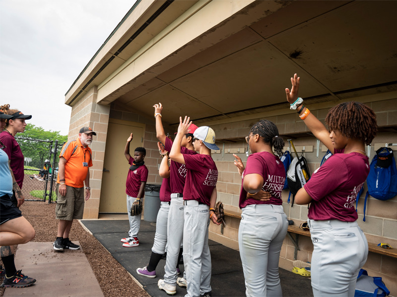 Attendees of the Cal Ripken Foundation camp cheer during a game.