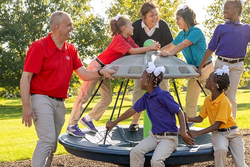 Elementary students at a playground with their houseparents