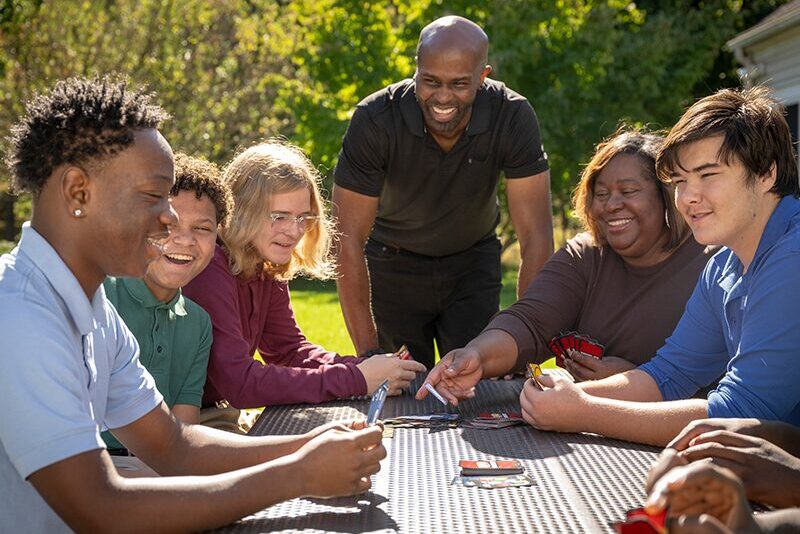 Students and houseparents playing a game
