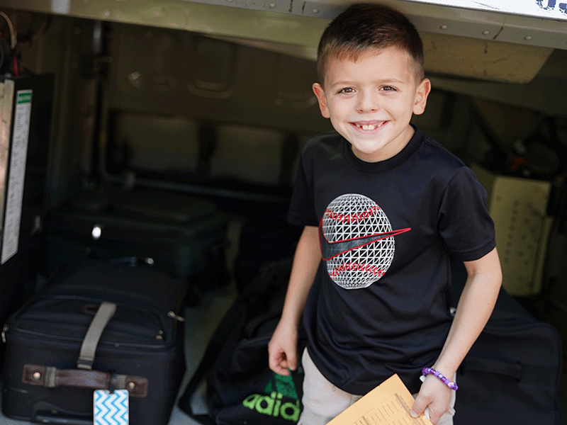 Milton Hershey School students loads his luggage on a charter bus on his way to his home community for a school break.