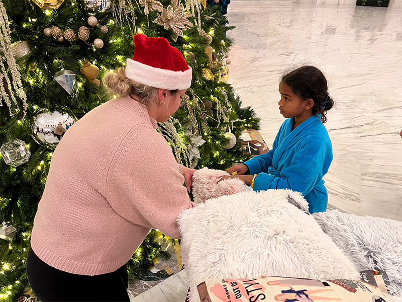 a person and a child in a santa hat