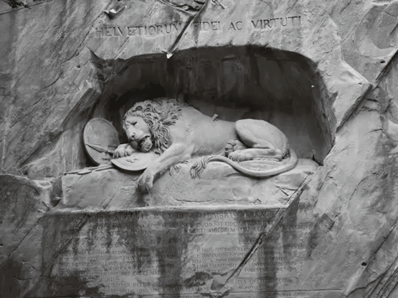 a statue of a lion sleeping in a cave