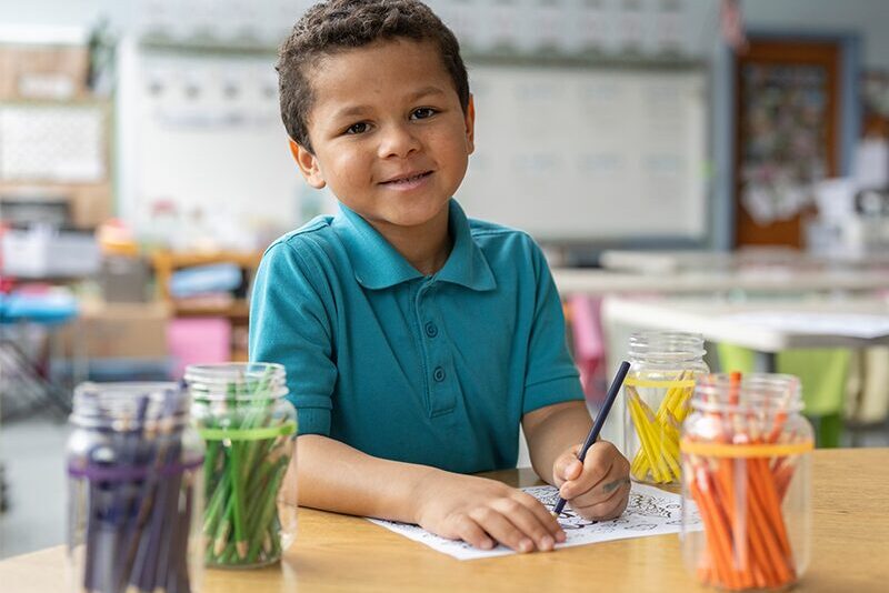 Elementary student coloring in class