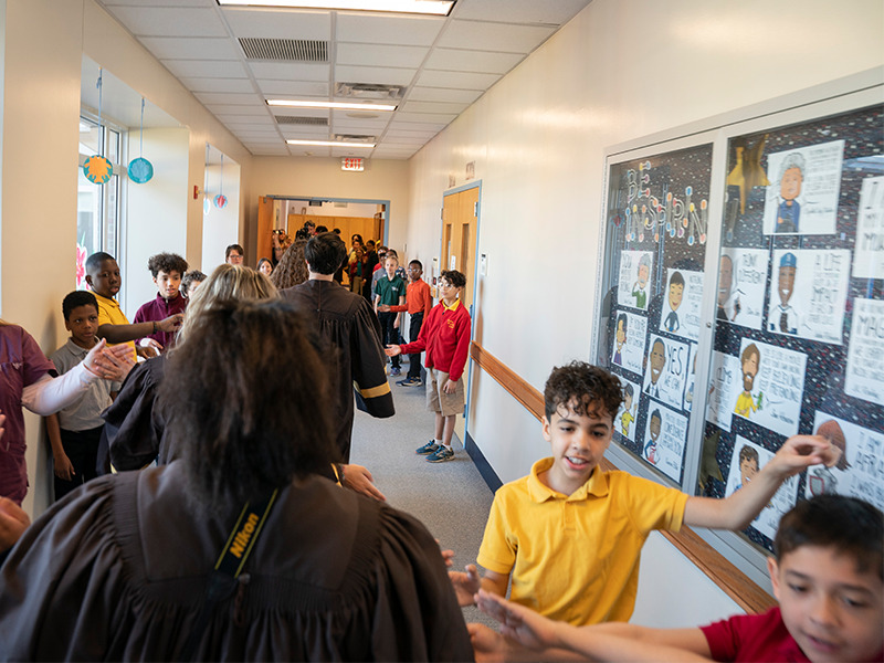 Milton Hershey School seniors walk through Memorial Hall for the annual high five event.