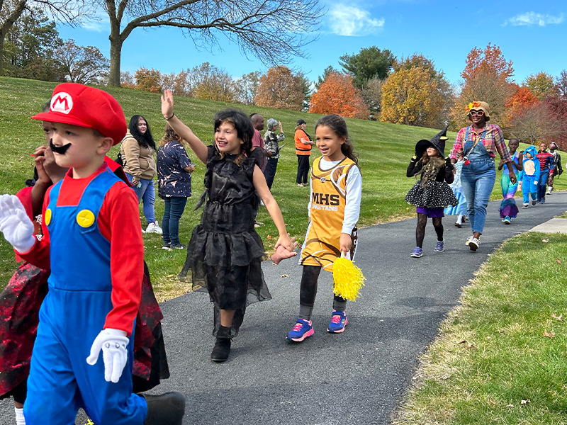 Milton Hershey School elementary students parade around the school in their Halloween costumes during Fall Family Weekend.