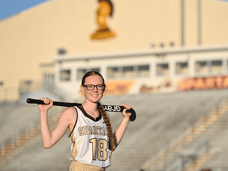 Milton Hershey School girls' field hockey player poses in front of MHS Athletic Complex.