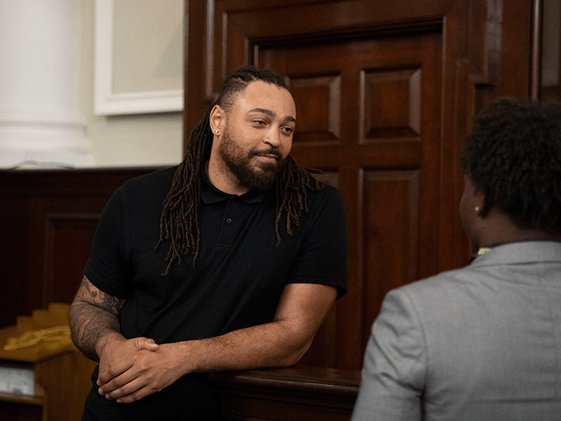 Milton Hershey School alumnus, Garry Gilliam '09, speaks with a current student.