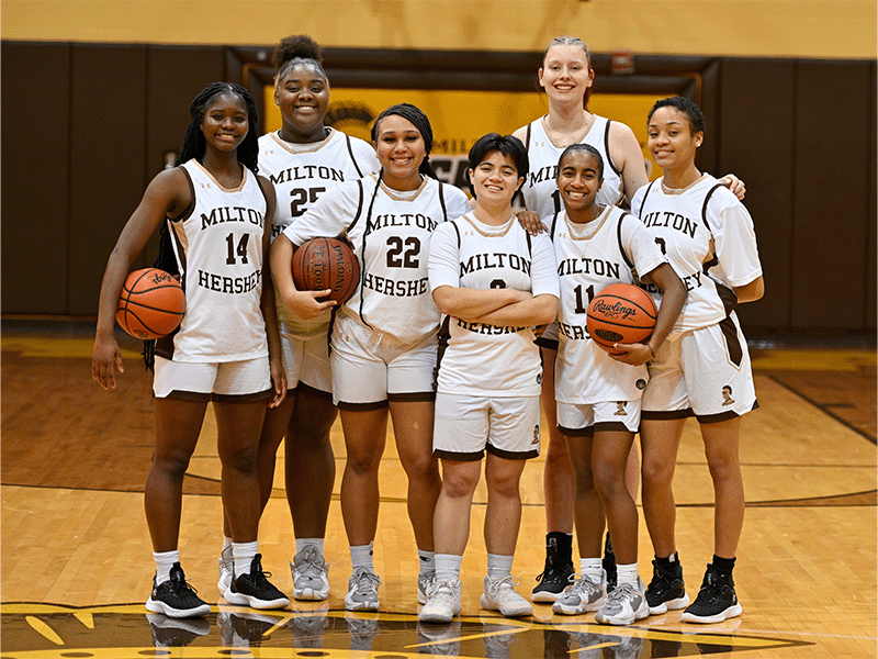Milton Hershey School girls' basketball players pose in Spartan Gym.