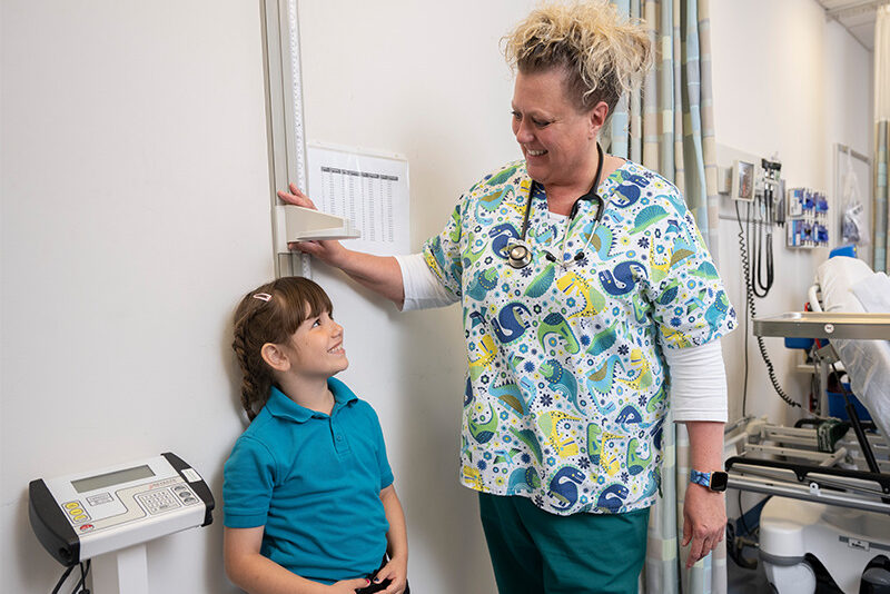 Milton Hershey School nurse with student in medical exam room.