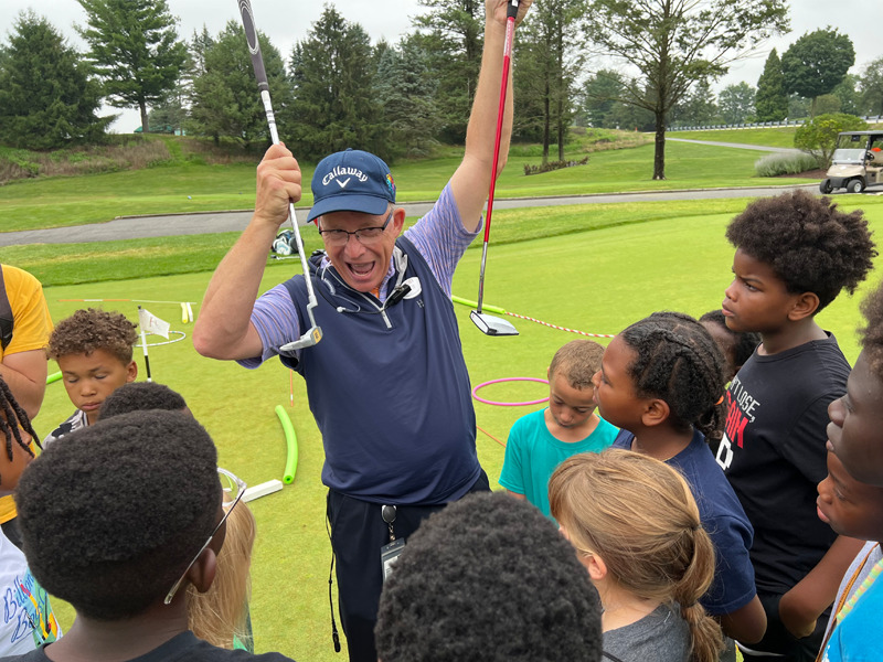 A Milton Hershey School students learn about clubs at the Hershey Country Club.