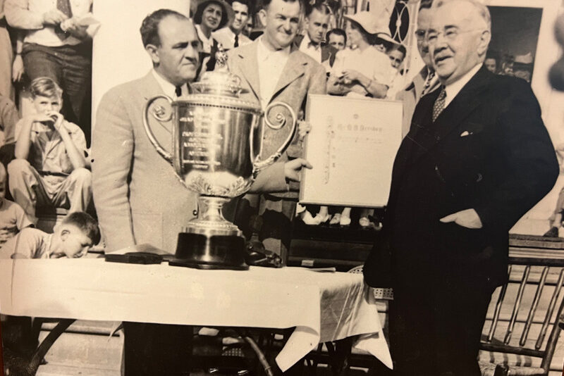 Milton S. Hershey presents the 1940 PGA Championship trophy at the Hershey Country Club.