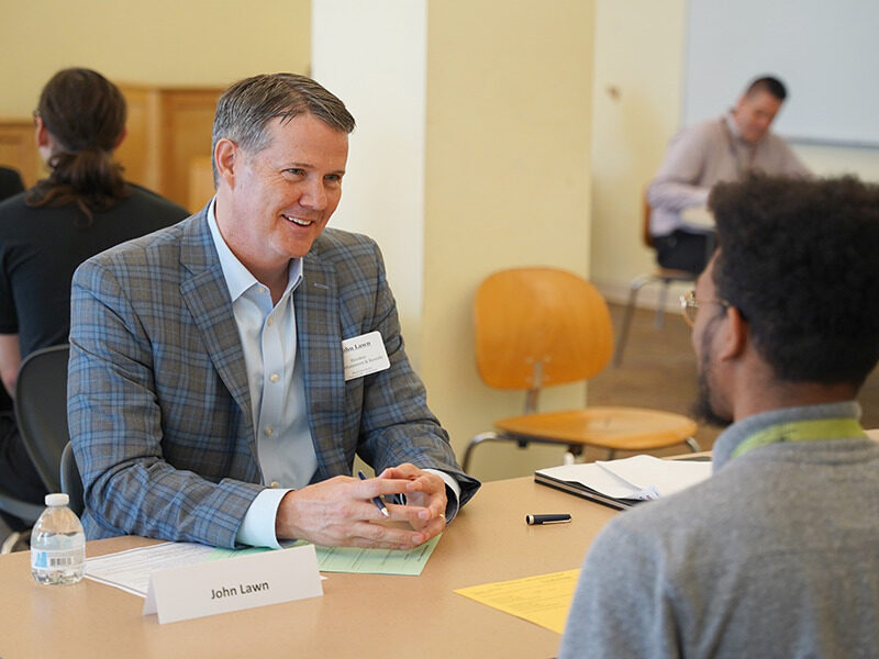 Hershey Enterainment & Resorts CEO John Lawn interacting with Milton Hershey School students at mock interviews