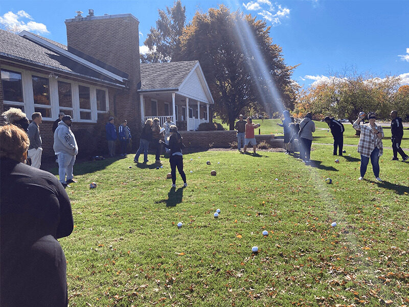 Milton Hershey School houseparents play games outside of a student home for professional development.