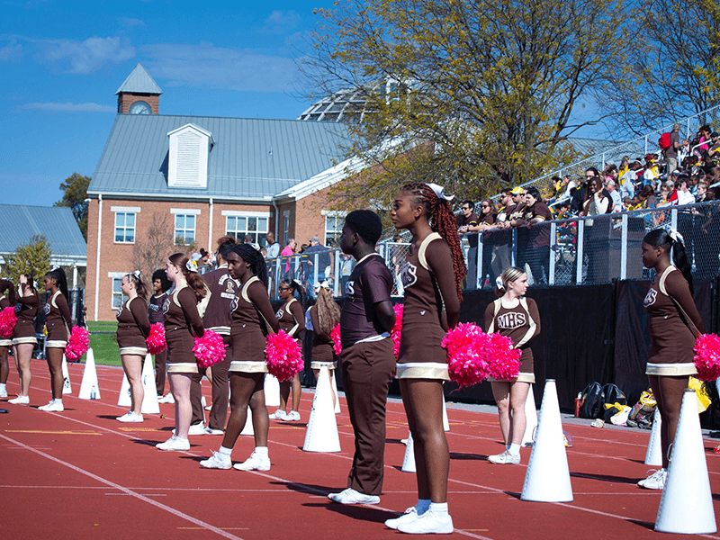 Milton Hershey School cheerleaders take part in the Homecoming Weekend football game.