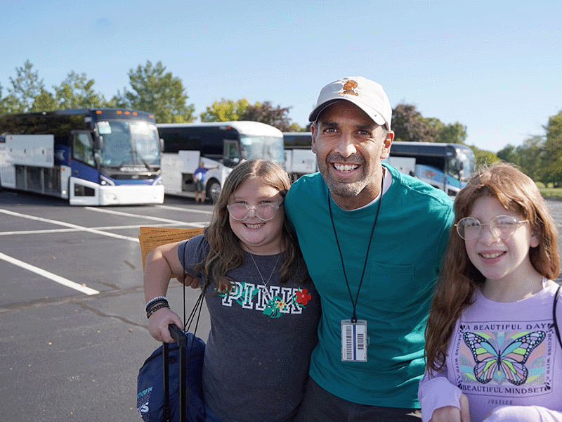 Milton Hershey School students stand with their houseparent as they prepare to depart campus for a school break.