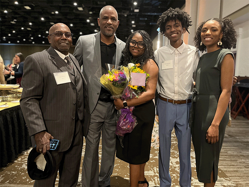 Karen Washington, Milton Hershey School houseparent, stands with her family at the YWCA of Greater Harrisburg's Tribute to Women of Excellence awards ceremony. 