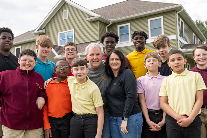 Milton Hershey School houseparents with students outside of student home.