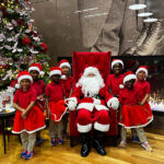 MHS students stand next to Santa Clause during the holidays.