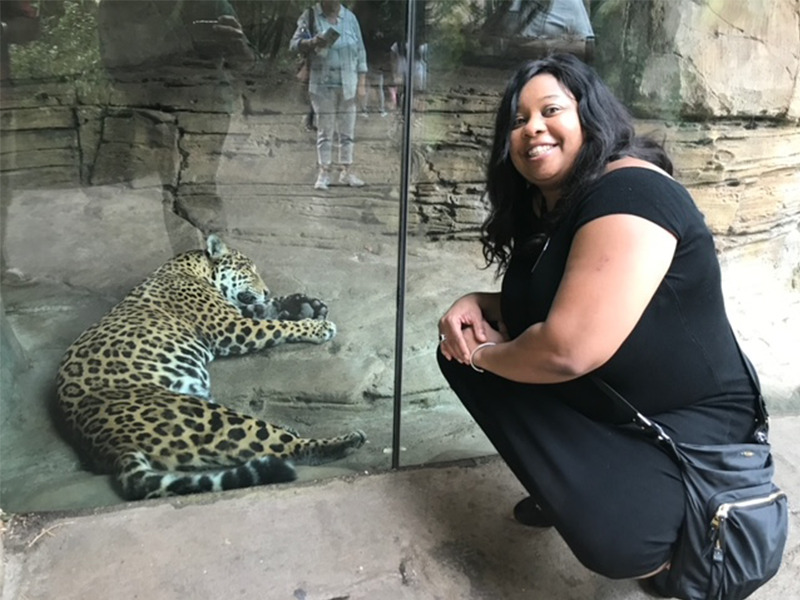 Milton Hershey School alumna Michele Y. Smith '90 sits at the zoo.