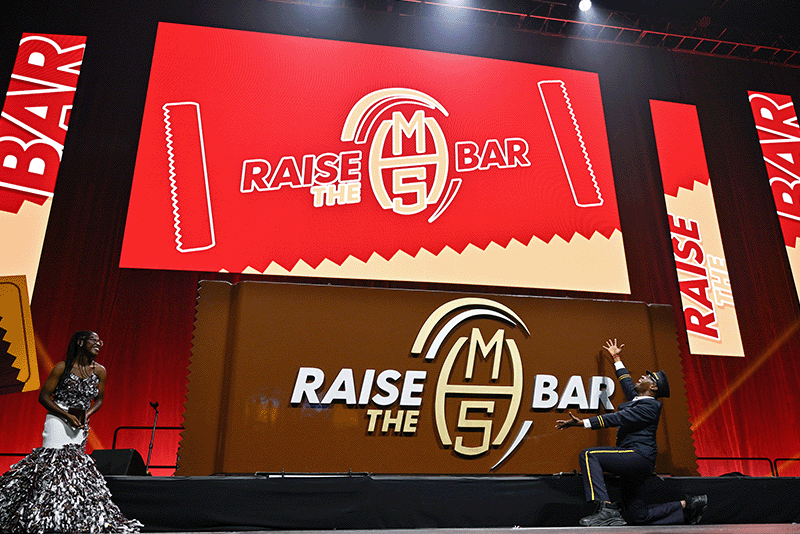 Milton Hershey School Opening of School Assembly 2024 host Marcus Paul James '99 and MHS student on stage