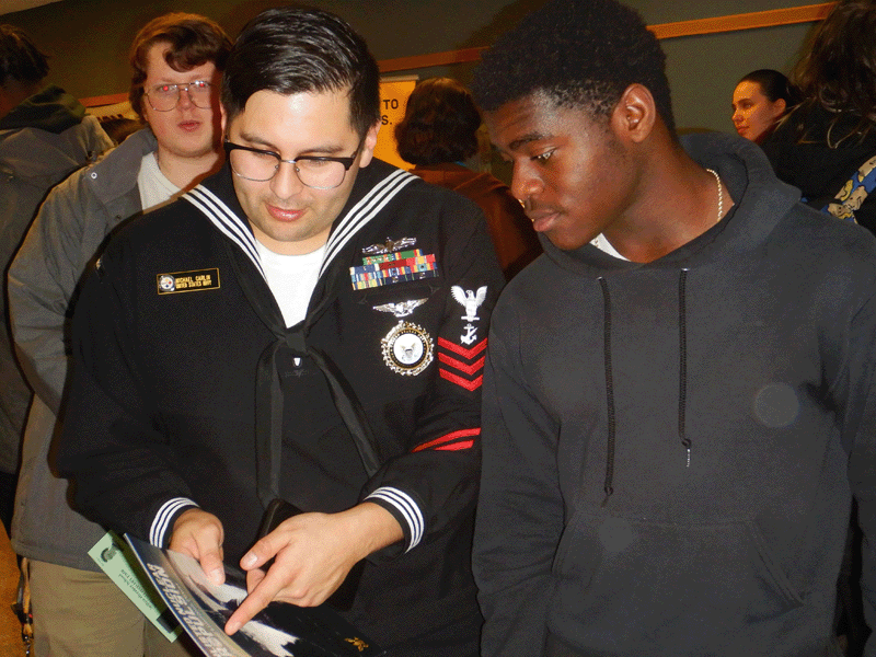 A representative from the United States Navy speaks to a Milton Hershey School student at the Postsecondary Career Fair.