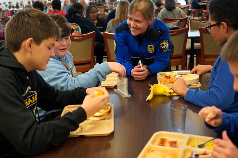 Milton Hershey School Campus Safety Officer Tracy Shull visits students at lunch.