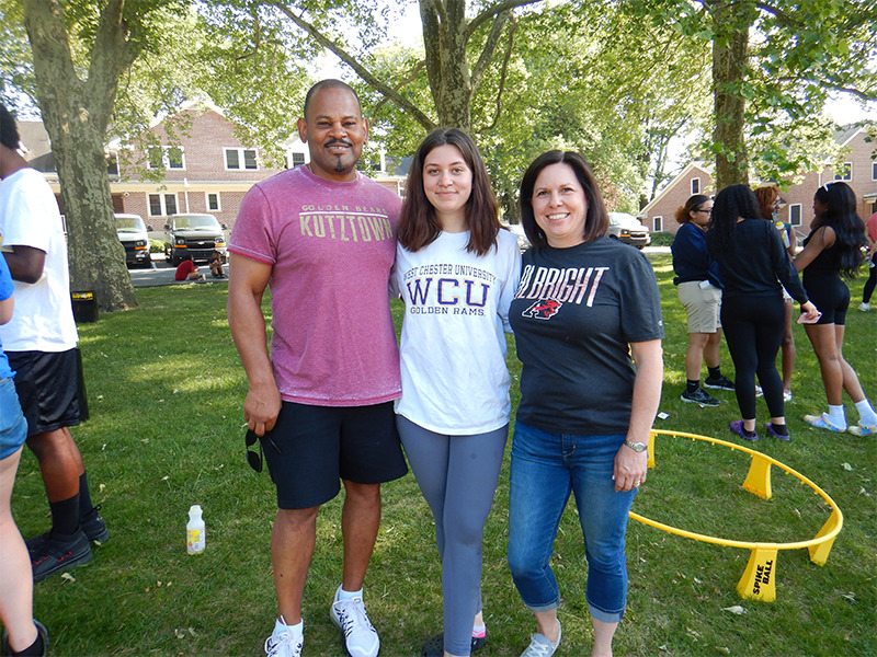 Milton Hershey School student stands with two college and career counselors.