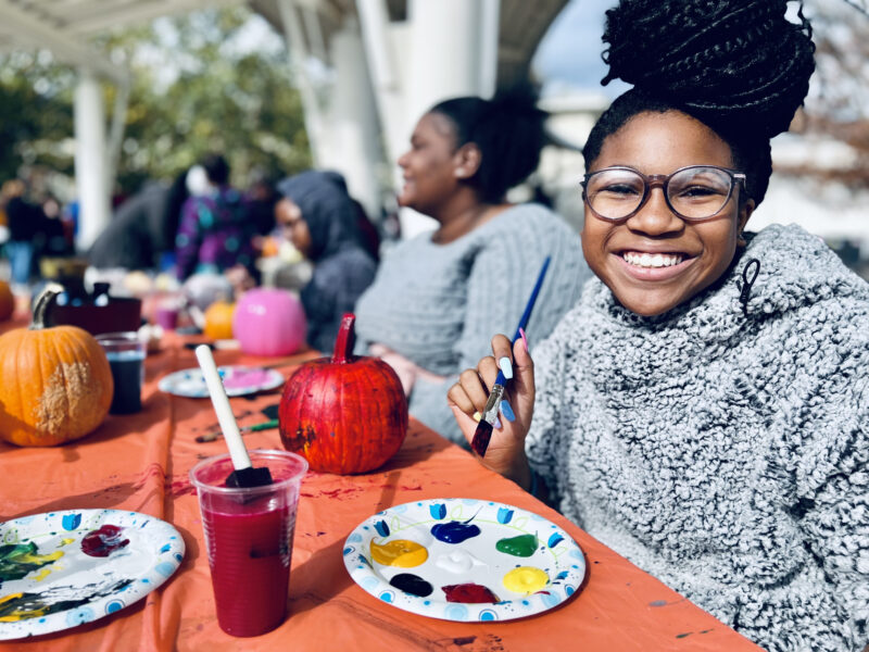 Milton Hershey School student at TL Fall Fest during Fall Family Weekend on Halloween