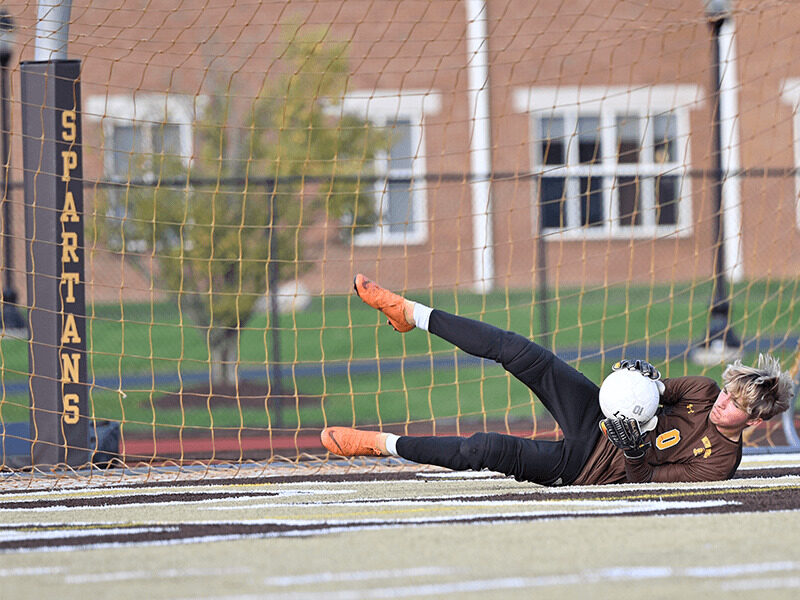 Milton Hershey School soccer player, Gage Thomas, catches the ball. 