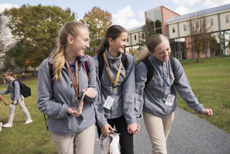 a group of children walking on a path