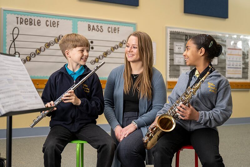 Elementary students with music teacher