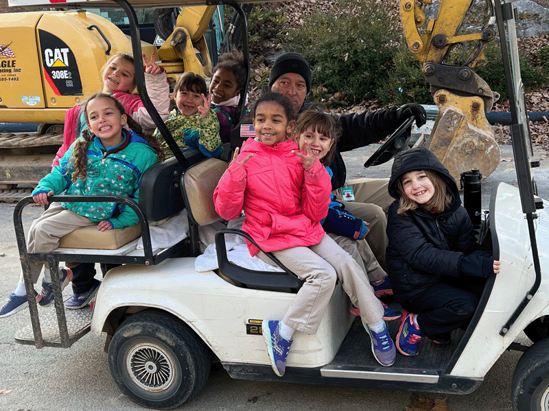 Milton Hershey School students pose for a picture on a Hersheypark golf cart near Wildcat's Revenge.