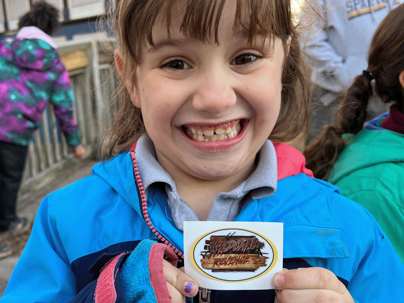 A Milton Hershey School student is excited to receive a Wildcat's Revenge sticker