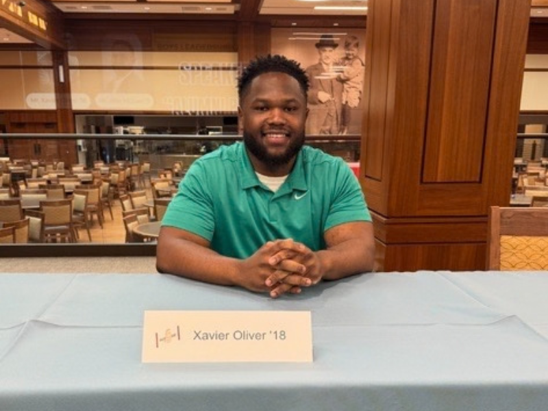 MHS alumnus Xavier Oliver '18 in MHS Founders Hall Cafeteria