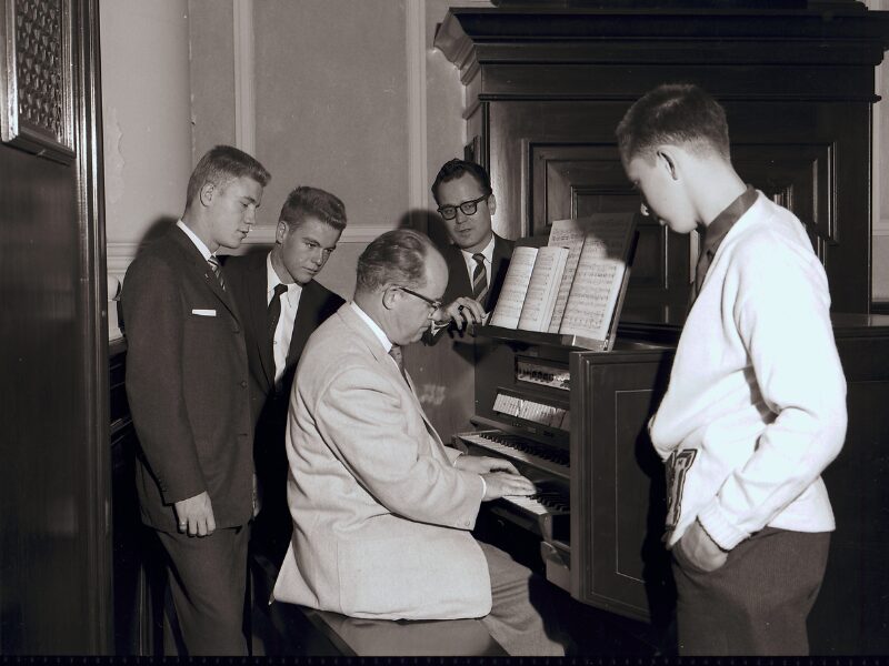 Purnell Payne playing organ with glee club