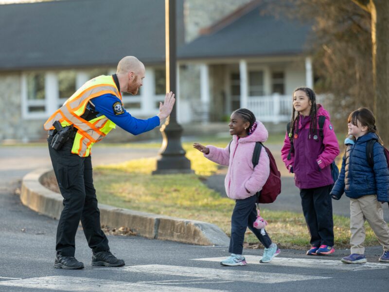 MHS security officers at crosswalk with elementary students