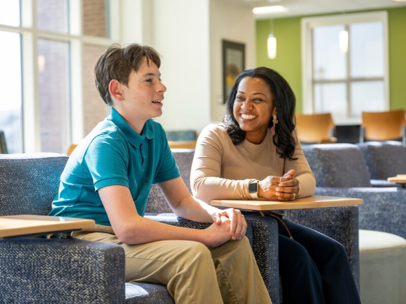 MHS student speaking with his mentor