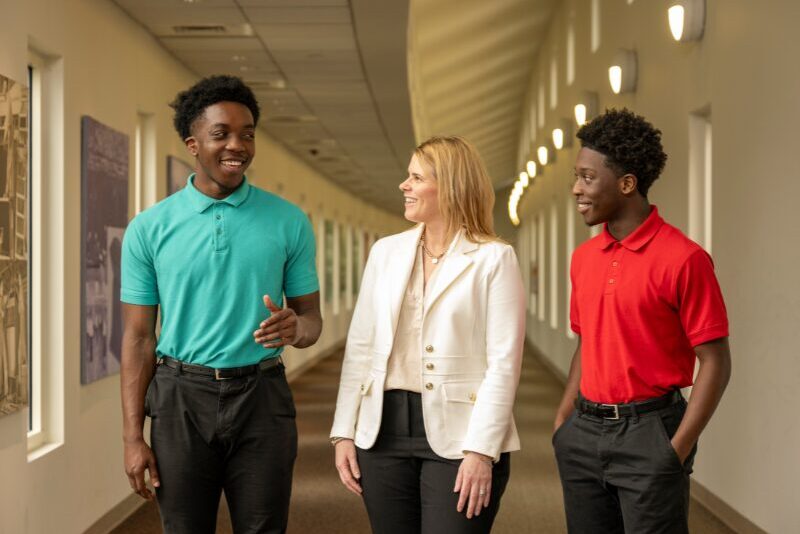 students walking in a hallway with their MOLD mentor
