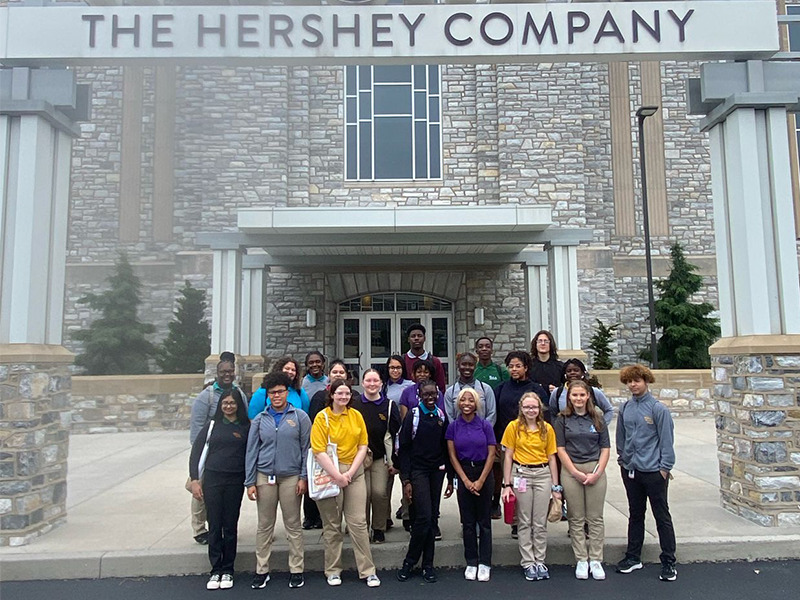 Milton Hershey School students stand outside The Hershey Company during their summer internship.